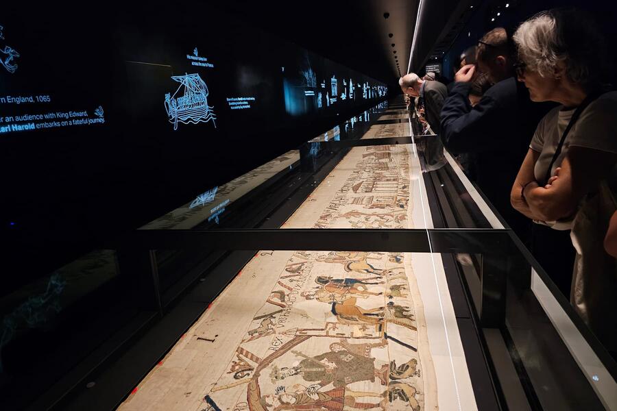 Visitors view the Bayeux Tapestry inside the 70-metre showcase at the British Museum.