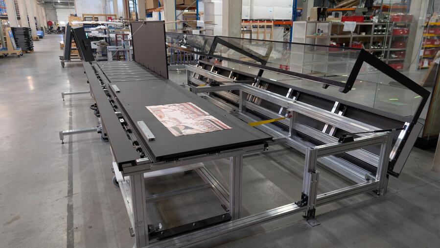 Workshop prototype testing of the table showcase’s movable support structure and hinged glass hoods.