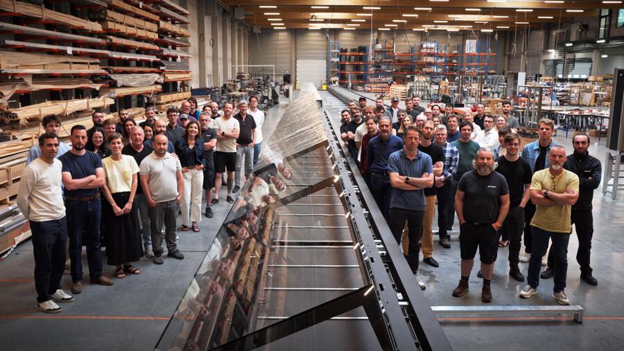 The Meyvaert team alongside the fully assembled 70-metre showcase in the workshop.